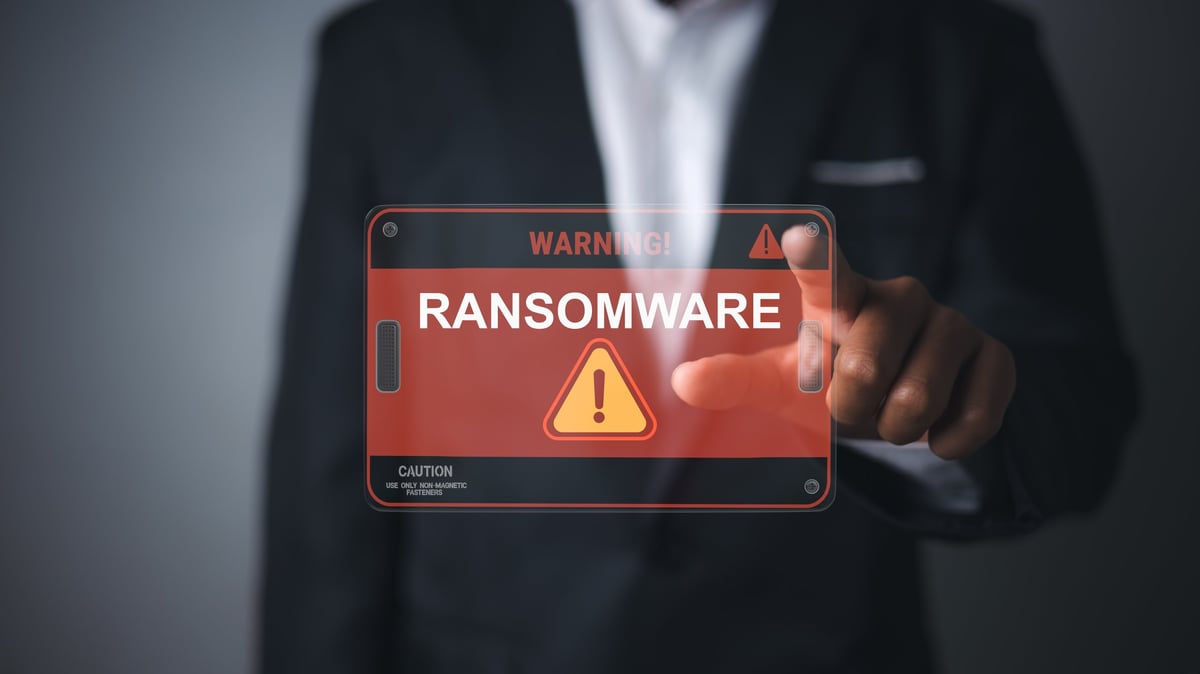 Ransomware cyber security attack. Data encryption threat protection. Cyber insurance and risk management. Digital network security breach alert. Businessman touching virtual warning screen.