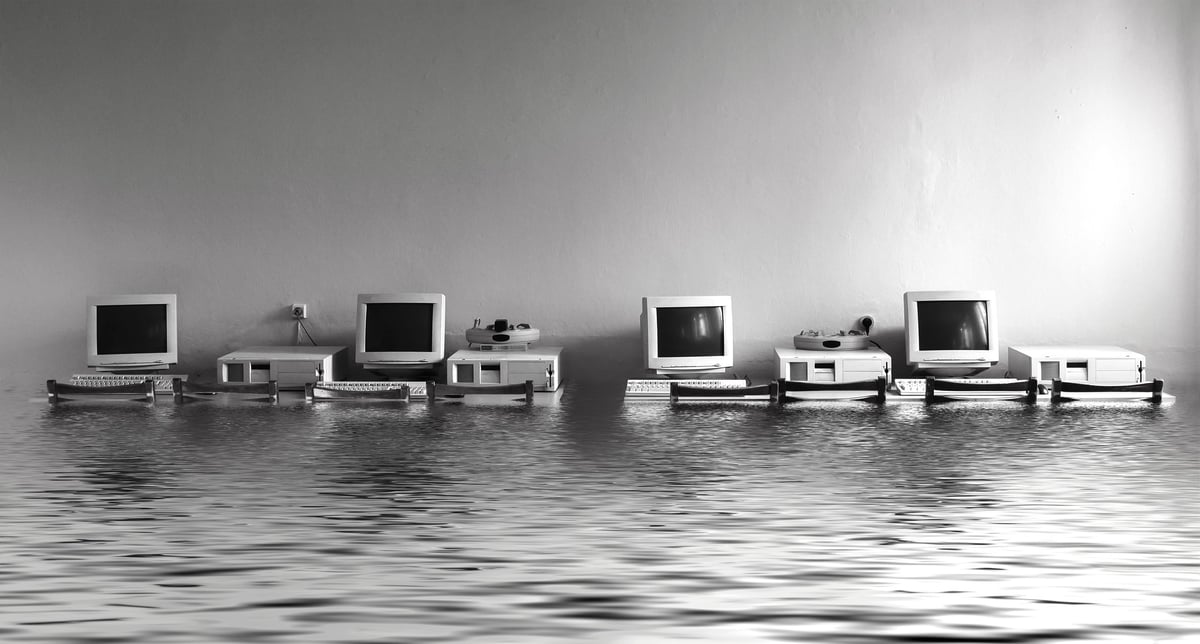 Black and white photo cabinet with computers flooded with water